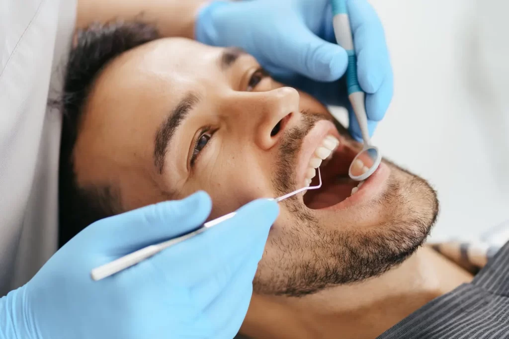 OPAL Dental Group dentist performing a comprehensive dental examination for a patient in Paramount, California